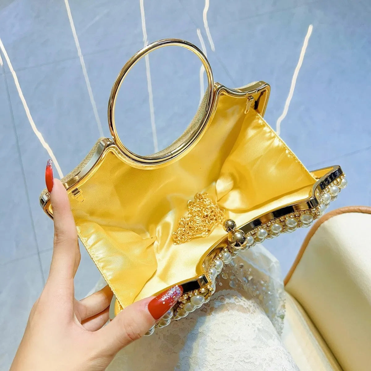 Gold and silver polyester crossbody handbag with diamond detail and hard pillow shape