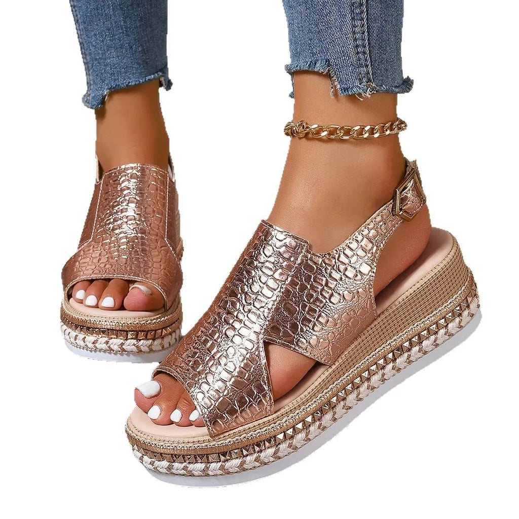 Gold Roman sandals with round toe, hollow-out design, and ankle buckle on rubber sole
