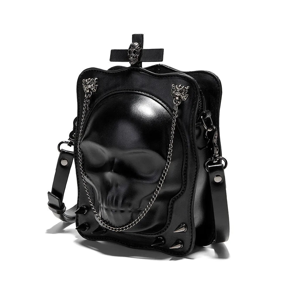 Black gothic crossbody bag with skull design, stitching, rivets, and chain details.