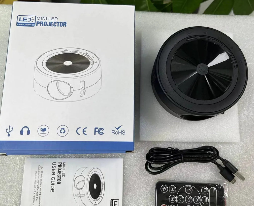 YT200 portable LED projector in four colour options showing 110mm diameter compact design