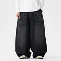 Men's plus-size light blue wide-leg baggy denim jeans on a hanger.