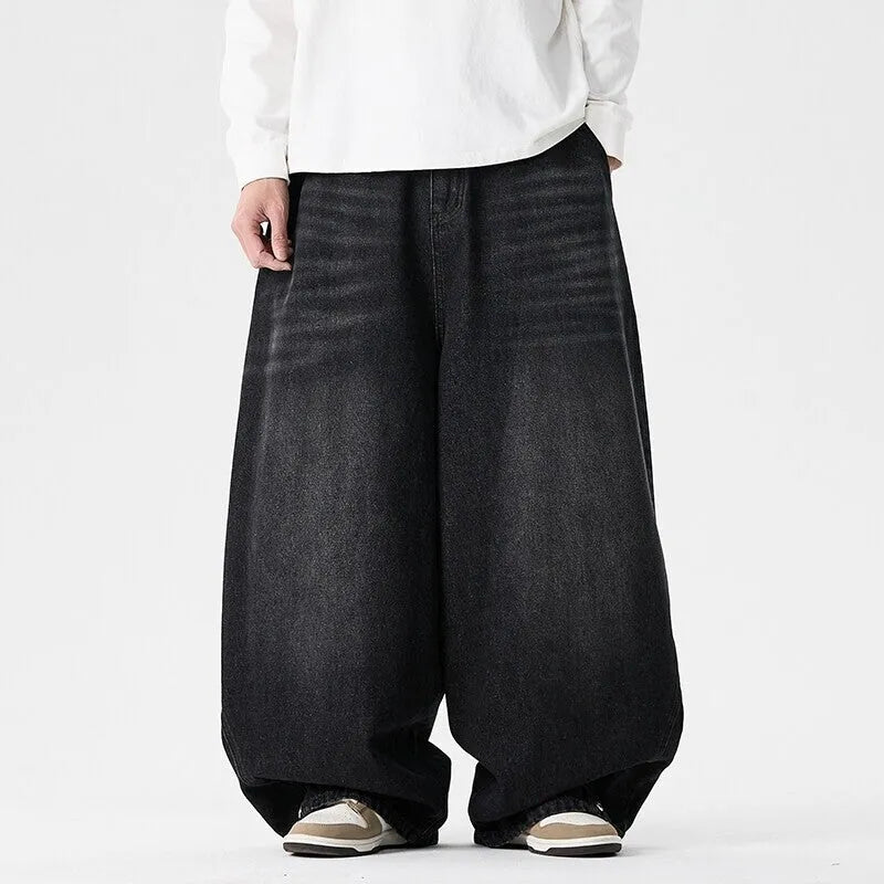 Men's plus-size light blue wide-leg baggy denim jeans on a hanger.