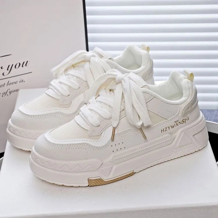 Beige children's lace-up board shoes with cross shoulder straps and a thick rubber sole.