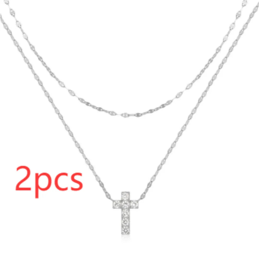 Sterling silver double layer cross pendant necklace with a clavicle chain in a gold tone finish.