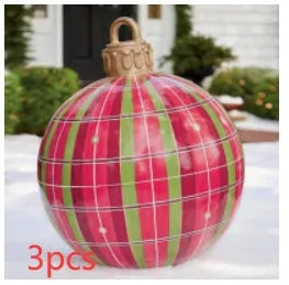 Large red and white striped inflatable Christmas ball ornament hanging on an outdoor tree