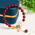 Tian Yu natural cinnabar bracelet with rabbit motif in purple gold sand colour