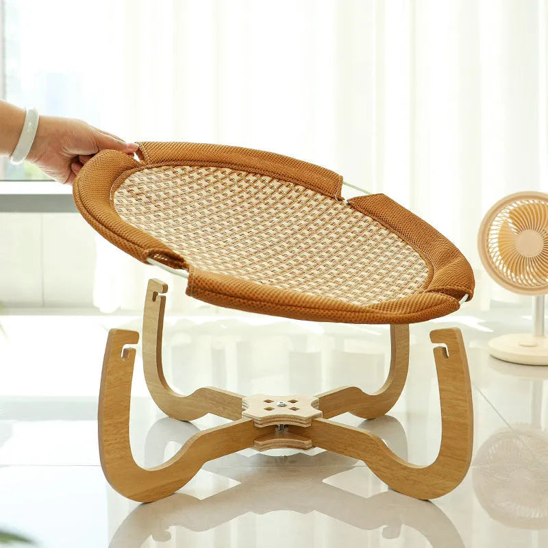 Brown woven rattan off-ground hammock bed for cats and small dogs.