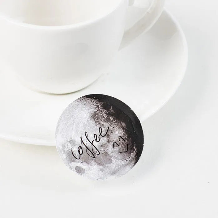 Black moon phase and planet decorative sticker set with 45 pieces on self-adhesive paper.