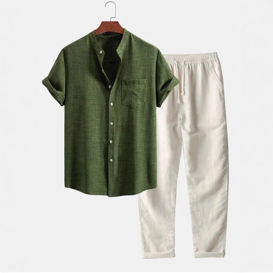 Men's slim-fit short-sleeved shirt with stand collar and digital print, shown with matching pants, shoes, and watch.