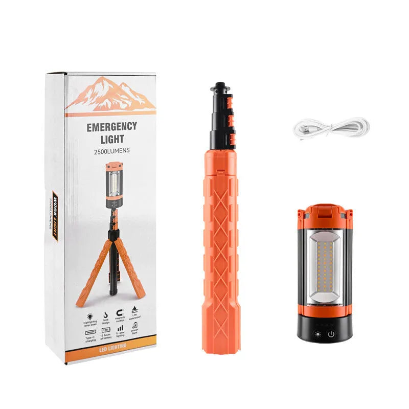 Retractable folding charging camping lantern in black and orange with bracket and pull string extended on a table