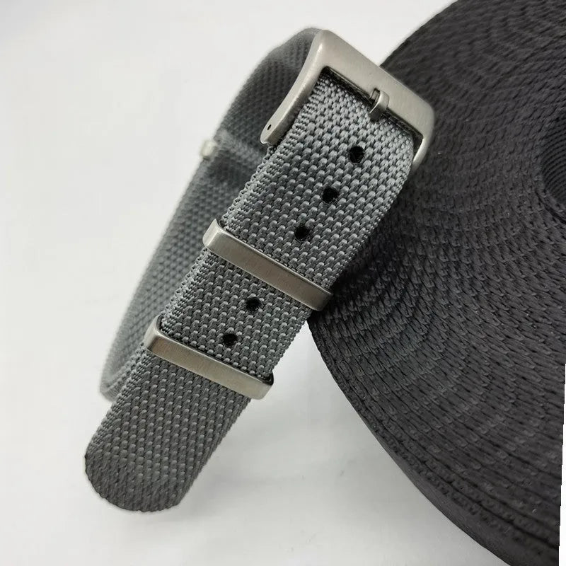 Nylon integrated watch strap in Army Green colour, shown next to Black, Deep Khaki, Light Gray, and Sapphire Blue options.