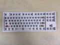 DIY mechanical keyboard kit with transparent case showing internal components and key puller tool
