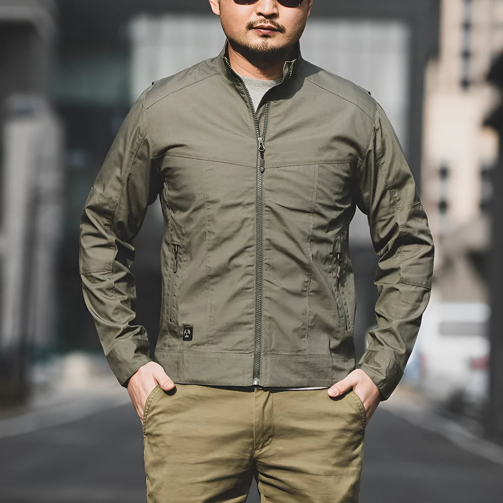 Man wearing a brown tactical camouflage jacket with multiple pockets outdoors.