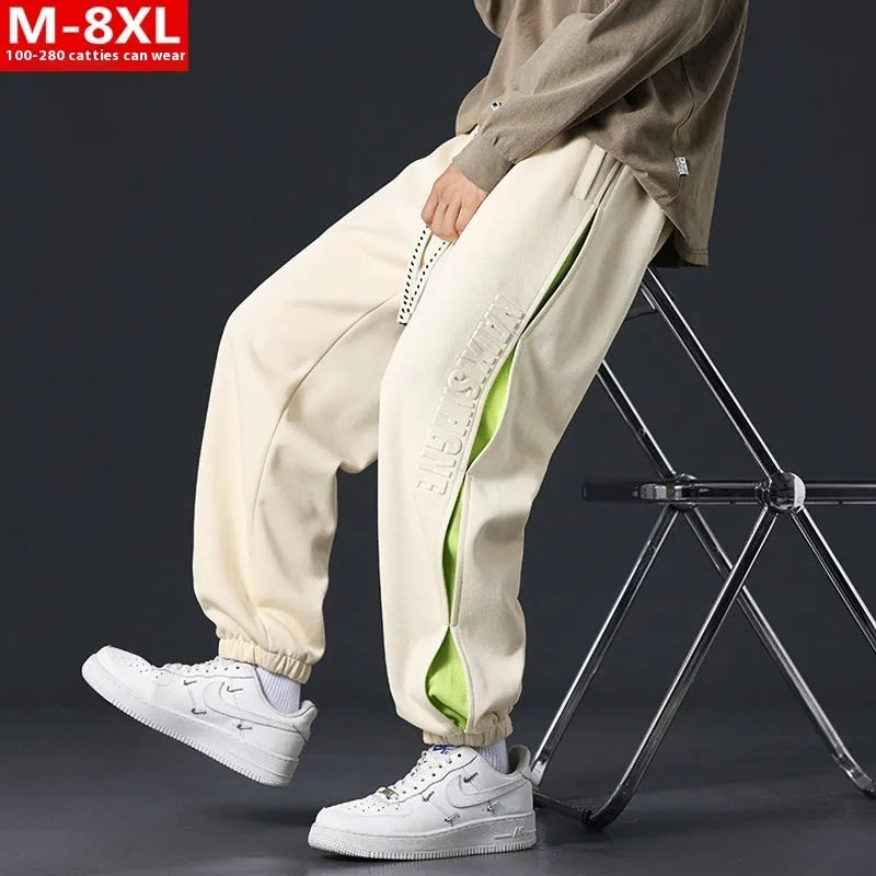 Men's loose fit cotton pants with elasticated ankle bands in grey green colour, showing collage stitching detail.