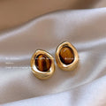 Three pairs of geometric tassel earrings with electroplated finishes in different styles