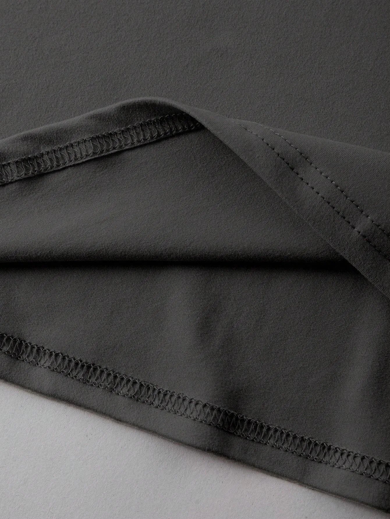 Loose short-sleeve cotton T-shirt on a hanger, showing round neckline, available in black, green, grey, and orange.