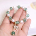 Green freshwater pearl bracelet with Chinese knot design and peace buckle closure
