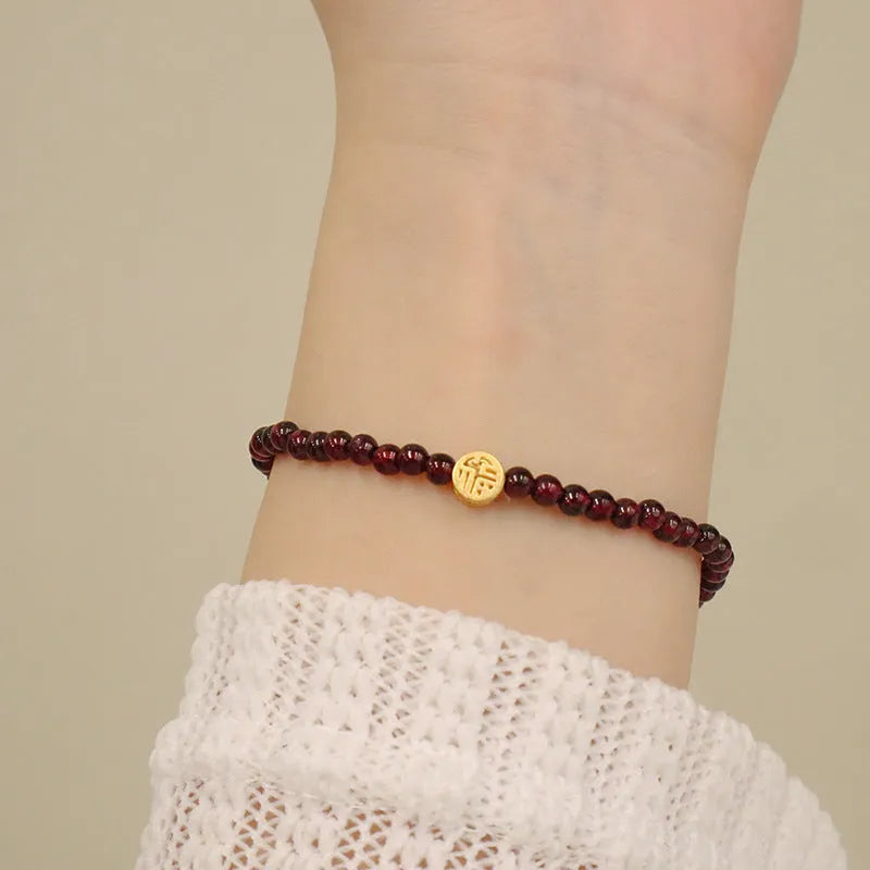 Chinese style gourd bracelet with imitation garnet stones and cultural motifs including Fu character design