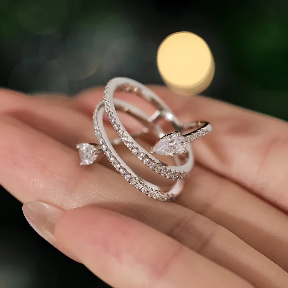 Sterling silver S925 drop-shaped ring in white gold colour on display