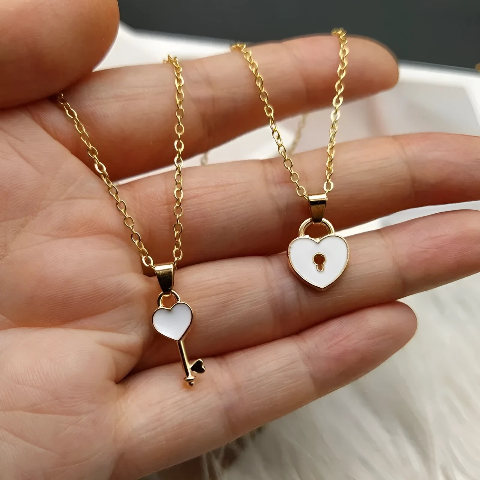 Small alloy lock and key pendant necklace set in black with 40cm chain on white background
