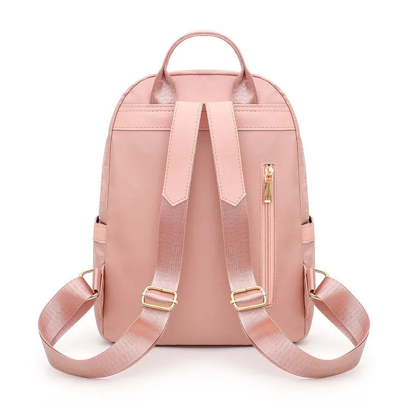 Black nylon casual backpack with square vertical shape, soft handle, and three-dimensional outer pocket