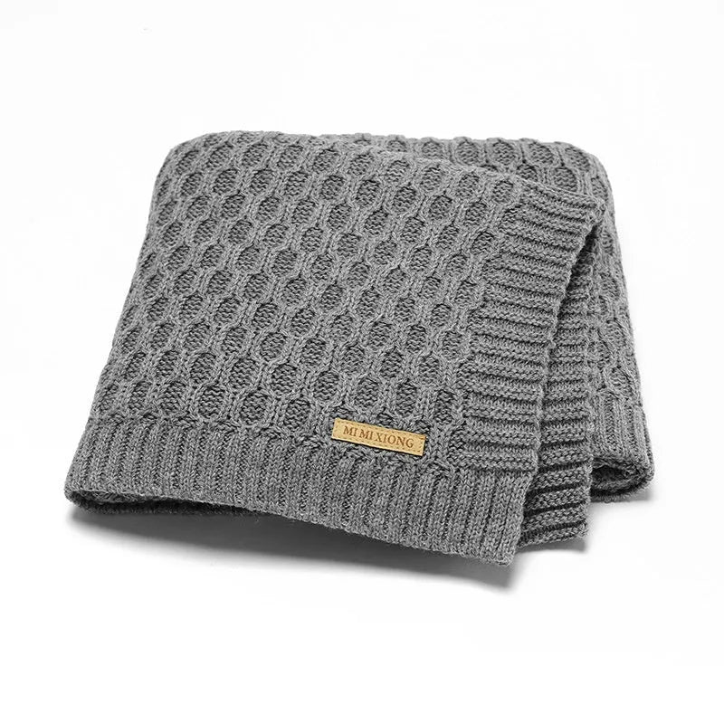 Solid colour infant blanket with raised line texture in beige khaki, laid flat showing 70x90cm size.