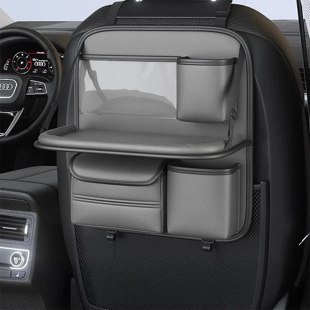Leather car seat storage bag with carrying handle shown in black, hanging over a car seat.