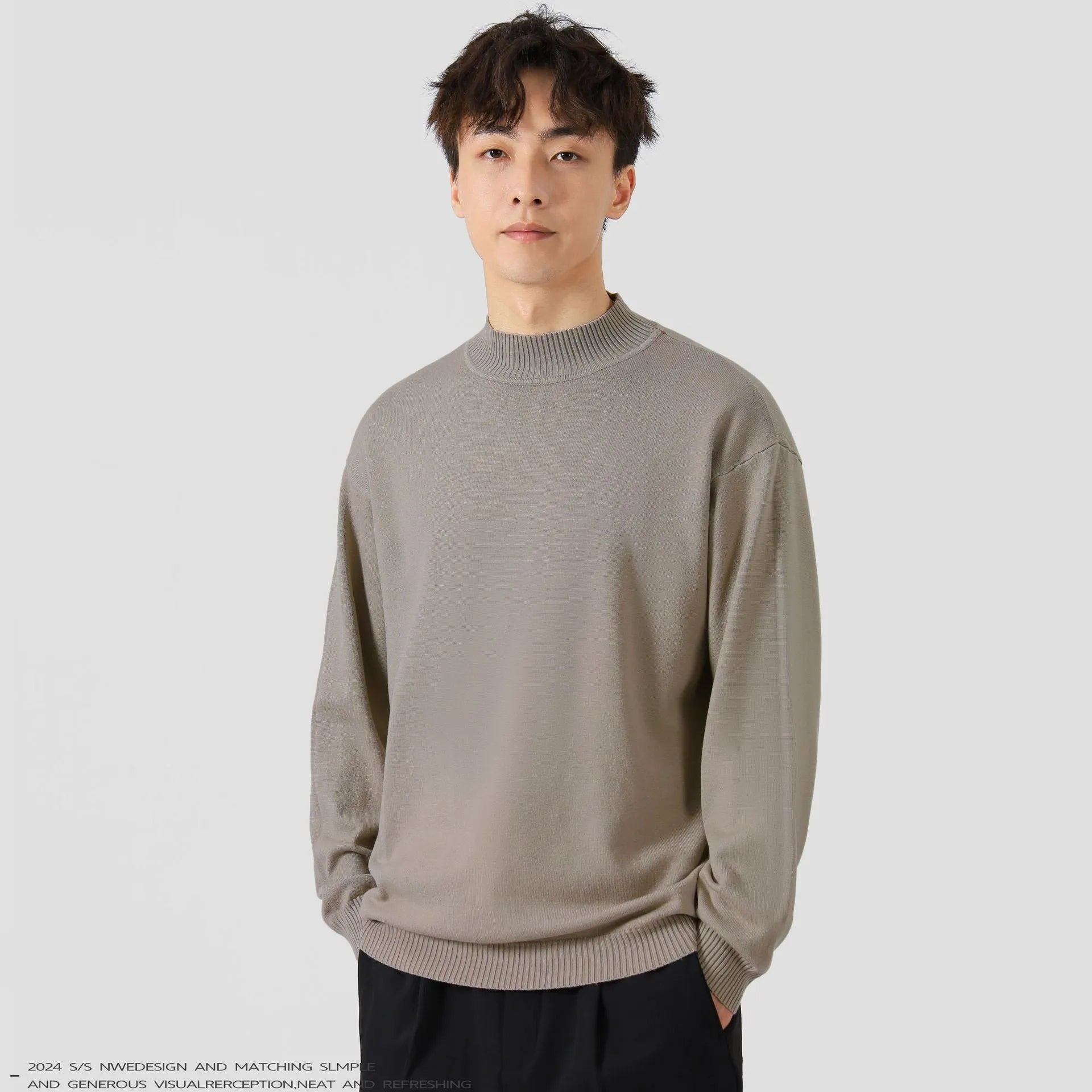 A man's loose-fitting, long-sleeve pullover sweater in a solid colour, showing a casual relaxed fit.