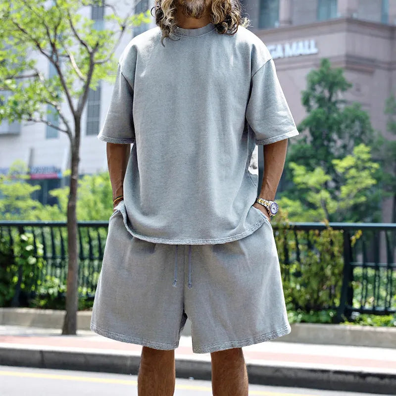 Men's casual sports suit set with grey round neck T-shirt and drawstring shorts on model
