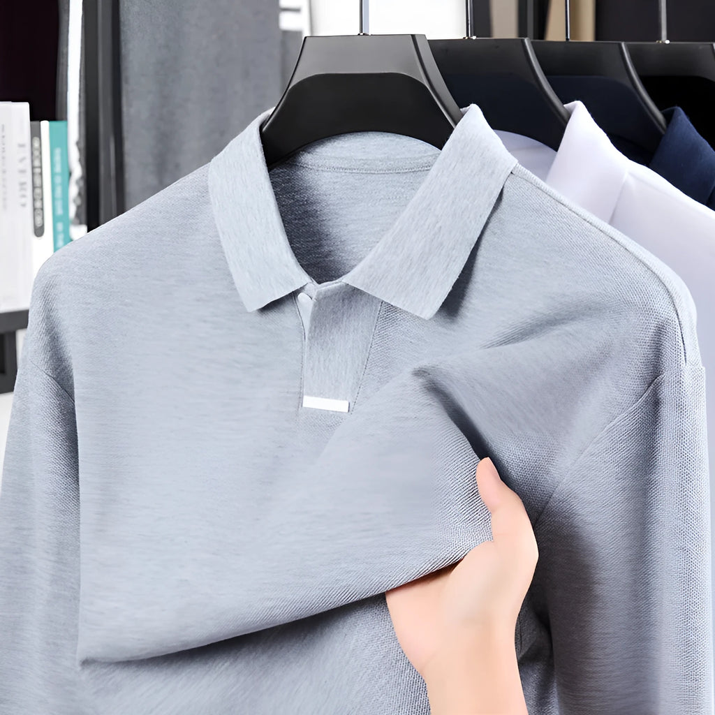 Men's grey loose fit cotton polo shirt with long sleeves and a lapel collar on a hanger.