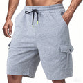 Heavy terry fabric cargo sports shorts with multiple pockets in light grey colour showing loose fit design