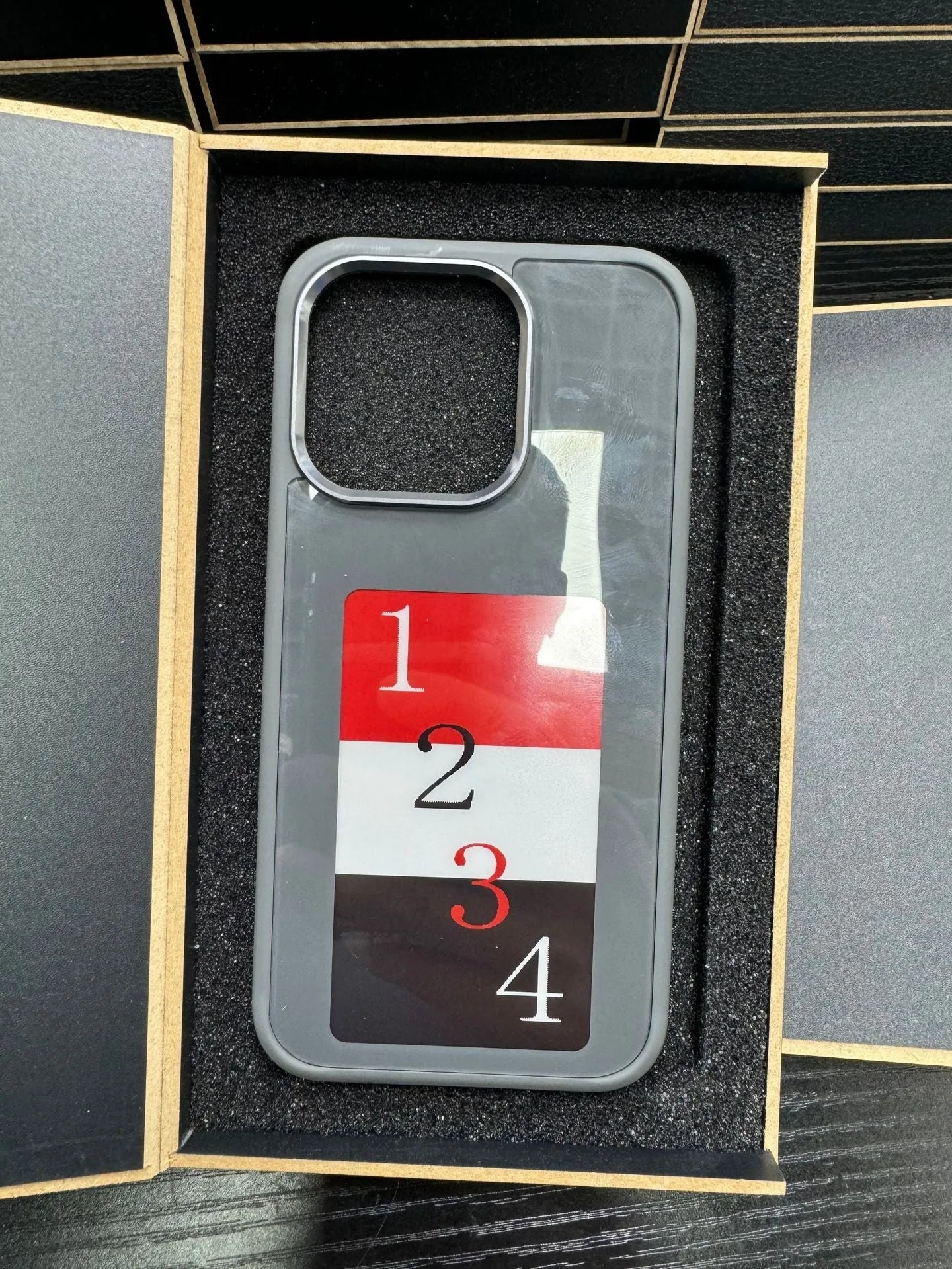 E-ink phone case for Apple iPhone with NFC screen projection displayed in black TPU, showing a custom image on the e-ink screen