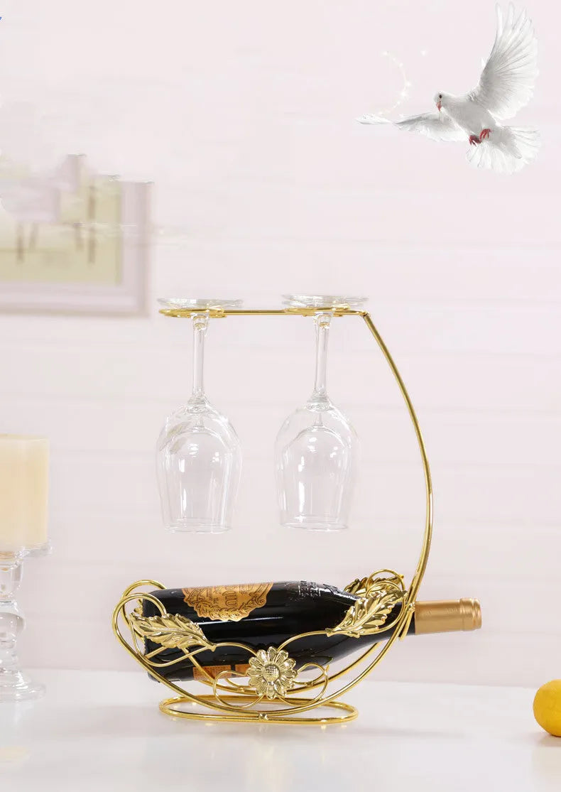 Iron wire wine rack decoration holding four goblets in a bronze finish on a shelf