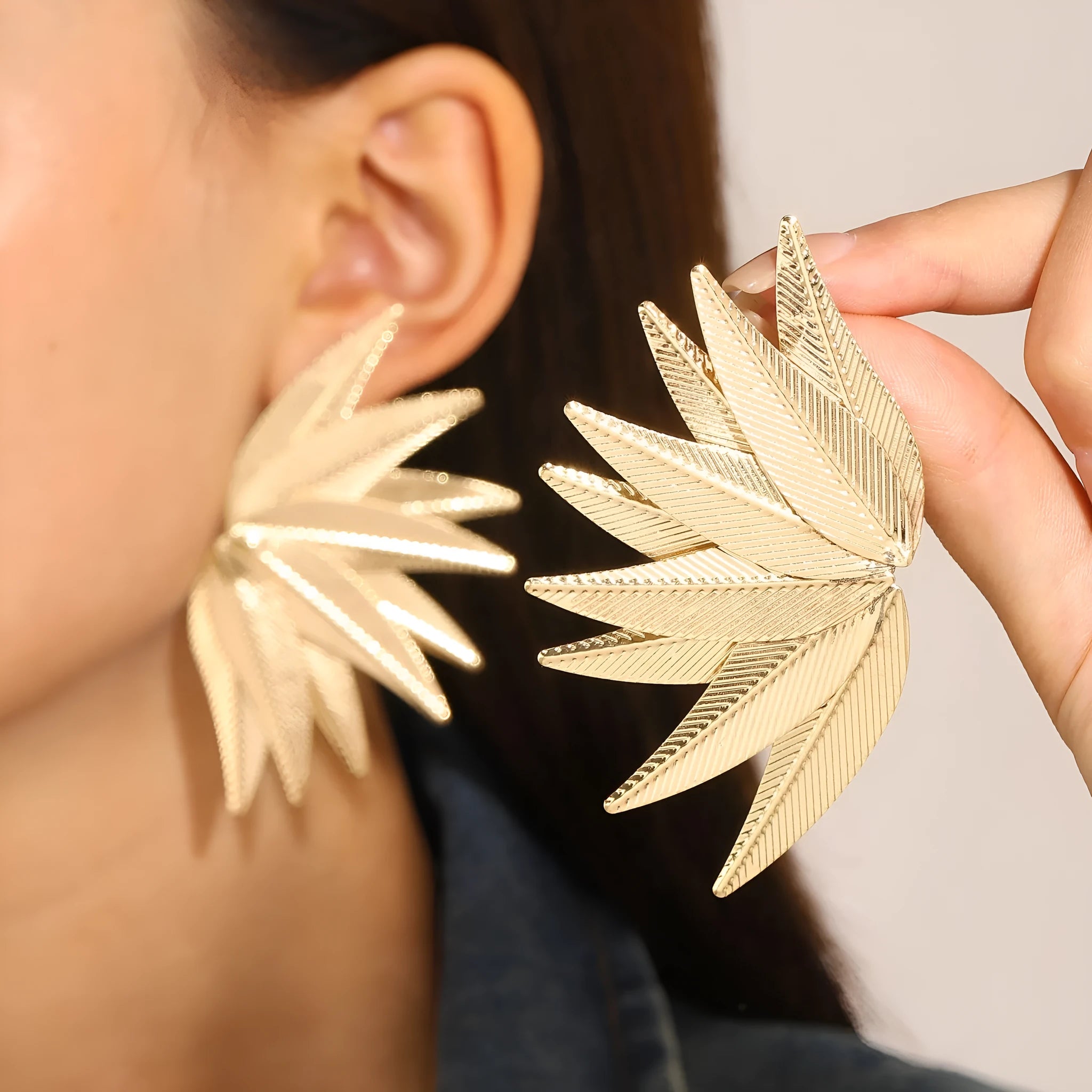 Leaves patch earrings in gold and white colour options with geometric leaf silhouette design