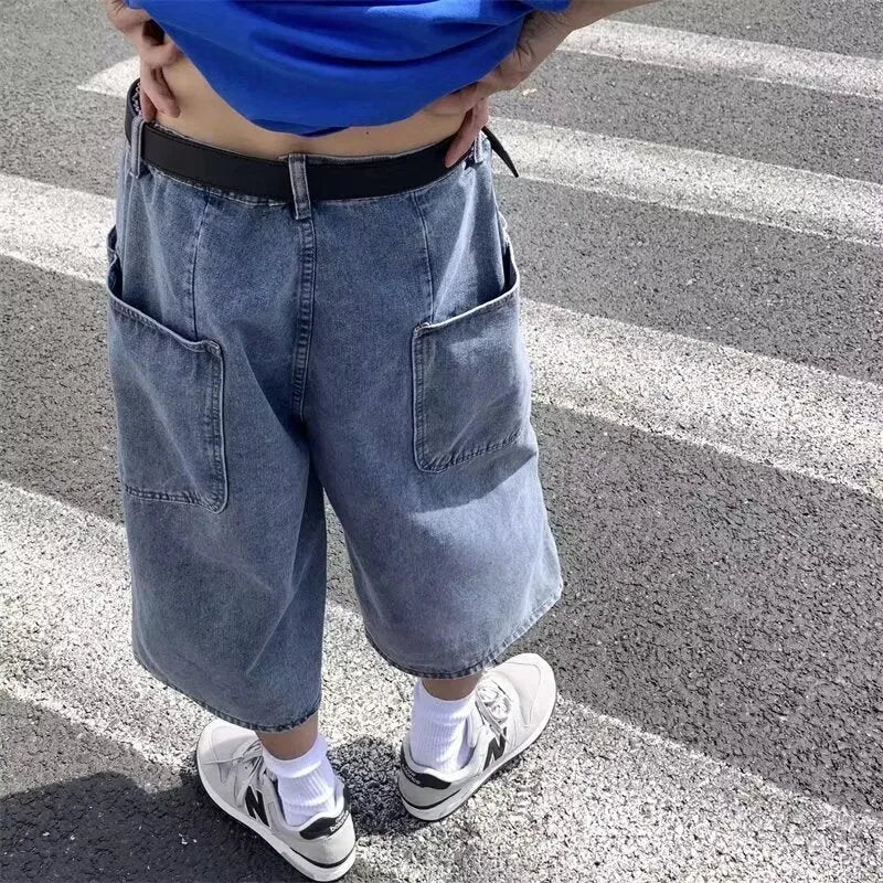 Blue washed denim pirate shorts for men with a high waist and straight leg, laid flat.