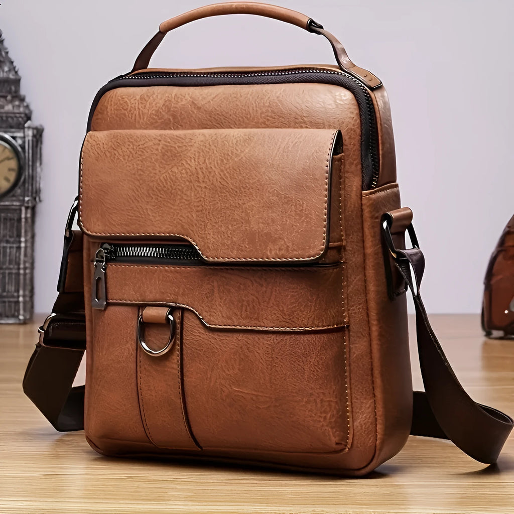 Men's brown PU leather crossbody messenger bag with metal zipper and adjustable strap on a plain background