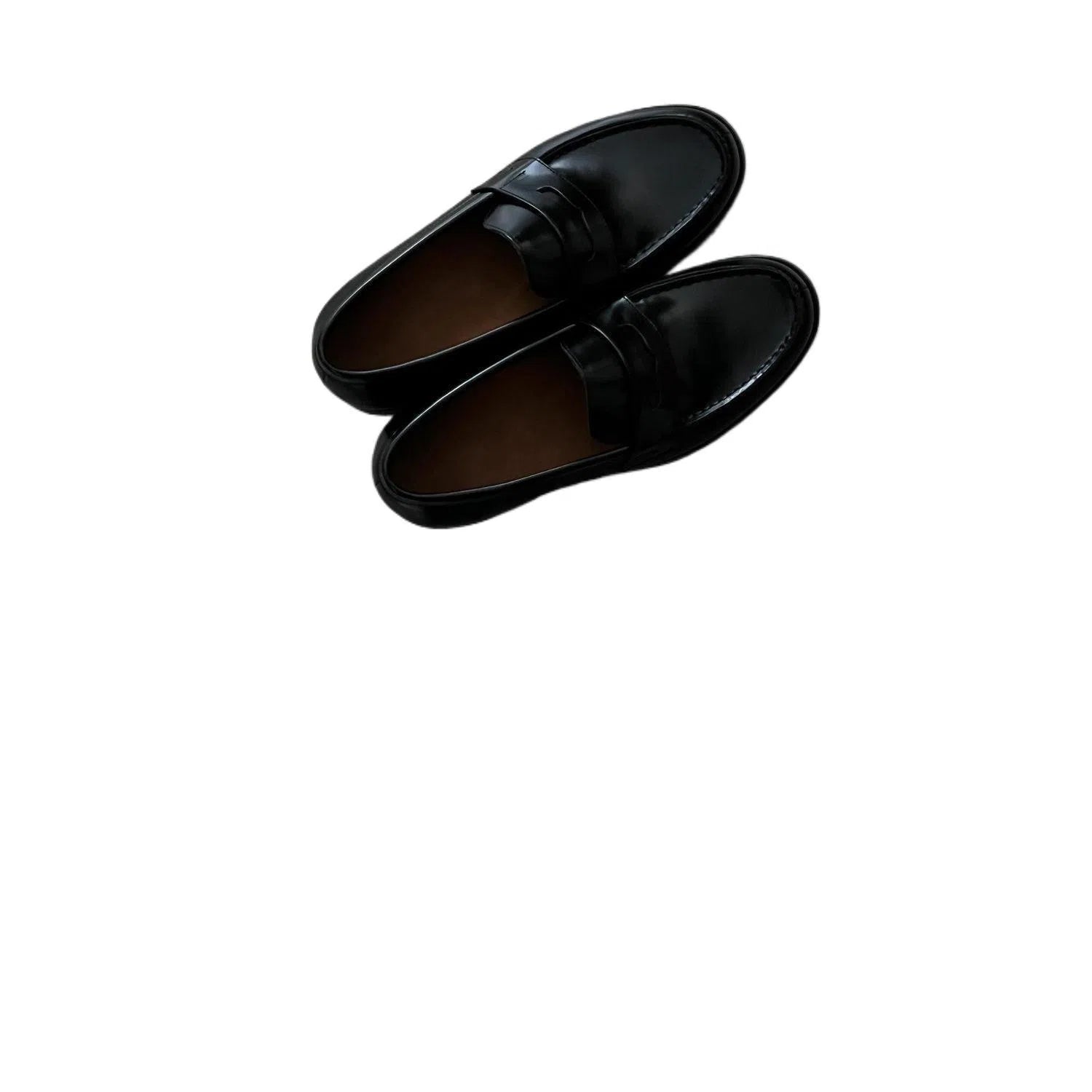 Men's black leather loafers with stitched seams, square heel, and vulcanised rubber sole on display