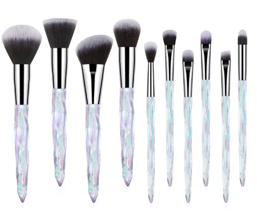 Ten crystal-handle foundation brushes with artificial fibre bristles in a set, showing black, blue, red, and yellow colour options.