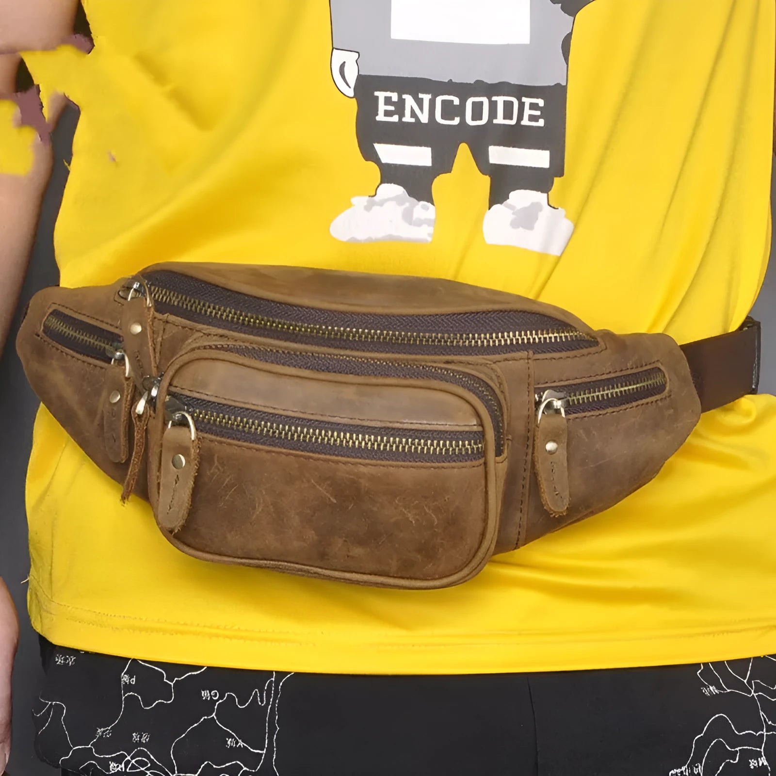 Brown leather messenger bag with single shoulder strap showing front pocket and dimensions