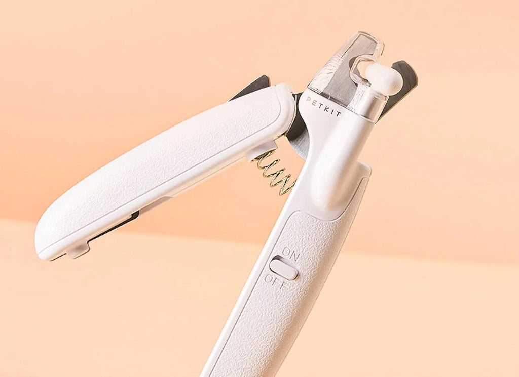 White LED pet nail clipper for cats and dogs with transparent anti-splash guard and file.
