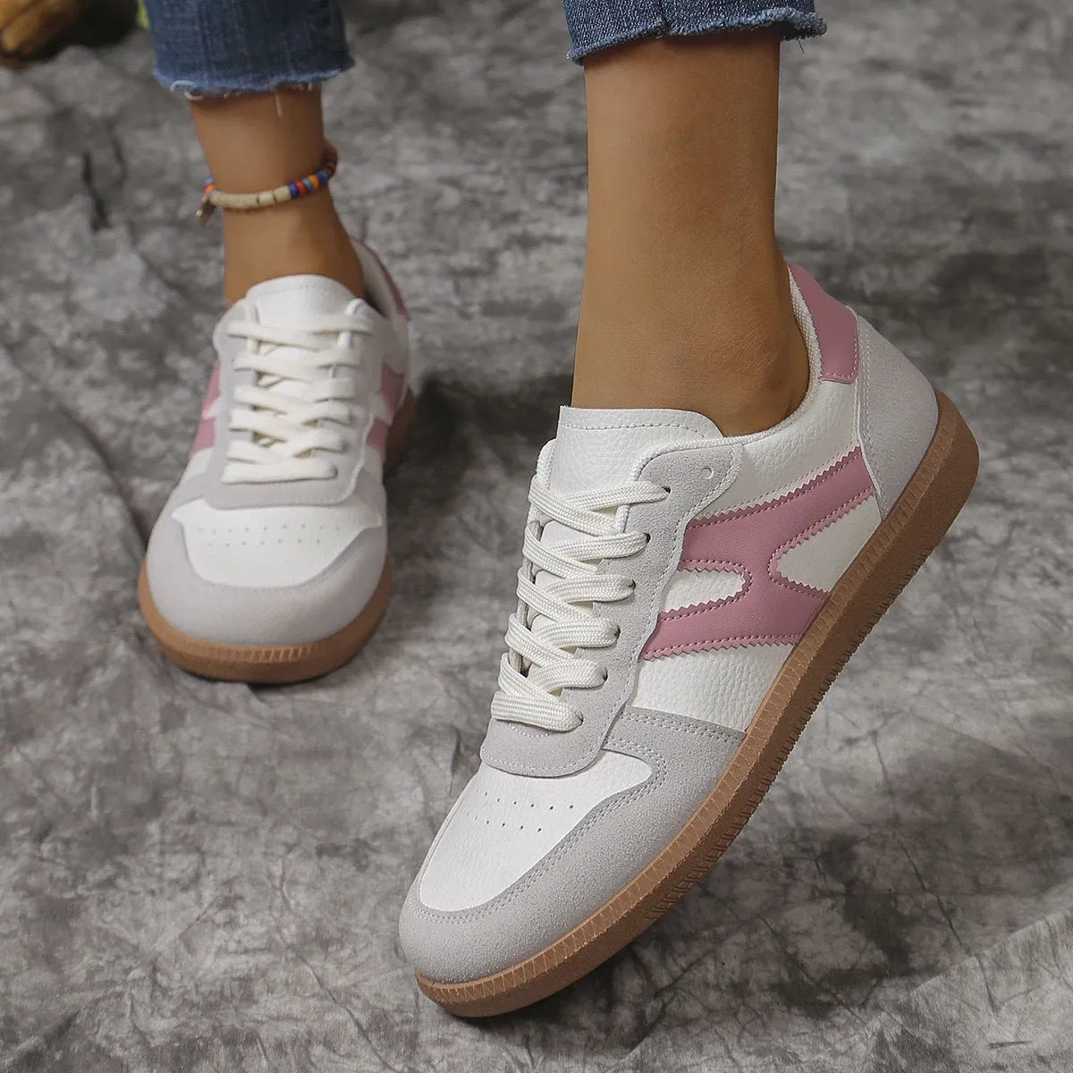 A pair of retro-style low-top lace-up sneakers in a selected colour on a plain background.