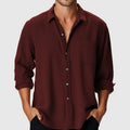 Man wearing a pure colour loose-fit polyester holiday shirt with a stand collar and long sleeves.