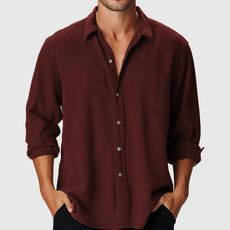 Man wearing a pure colour loose-fit polyester holiday shirt with a stand collar and long sleeves.