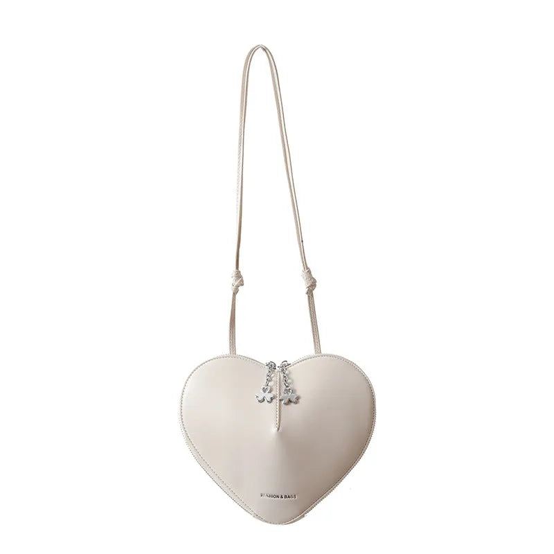 Women's heart-shaped PU crossbody bag in milky white with single shoulder strap and sandwich pocket