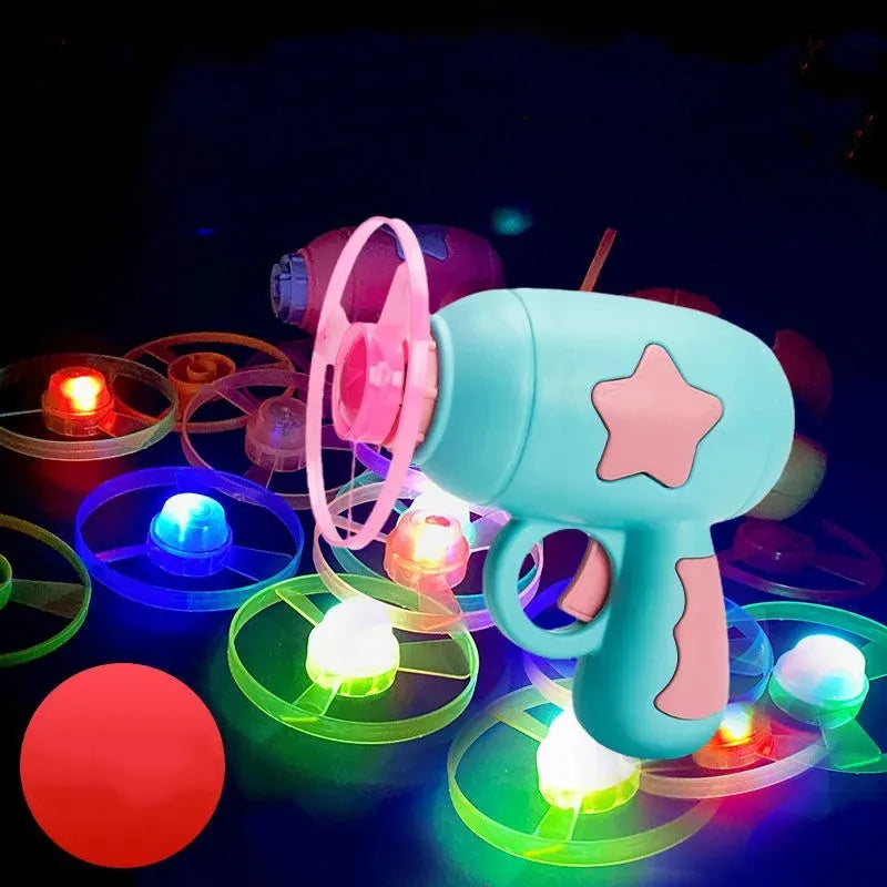 Blue flying saucer launcher gun and three LED flashing discs on a yellow background.