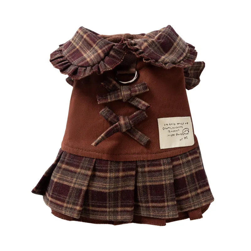 Fleece-lined brown plaid pet sweater dress with ruffle trim on a small dog, showing stretchable knit and skirt silhouette