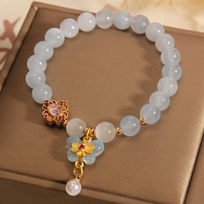 Women's crystal bracelet with aquamarine butterfly pendant and rhinestone decoration