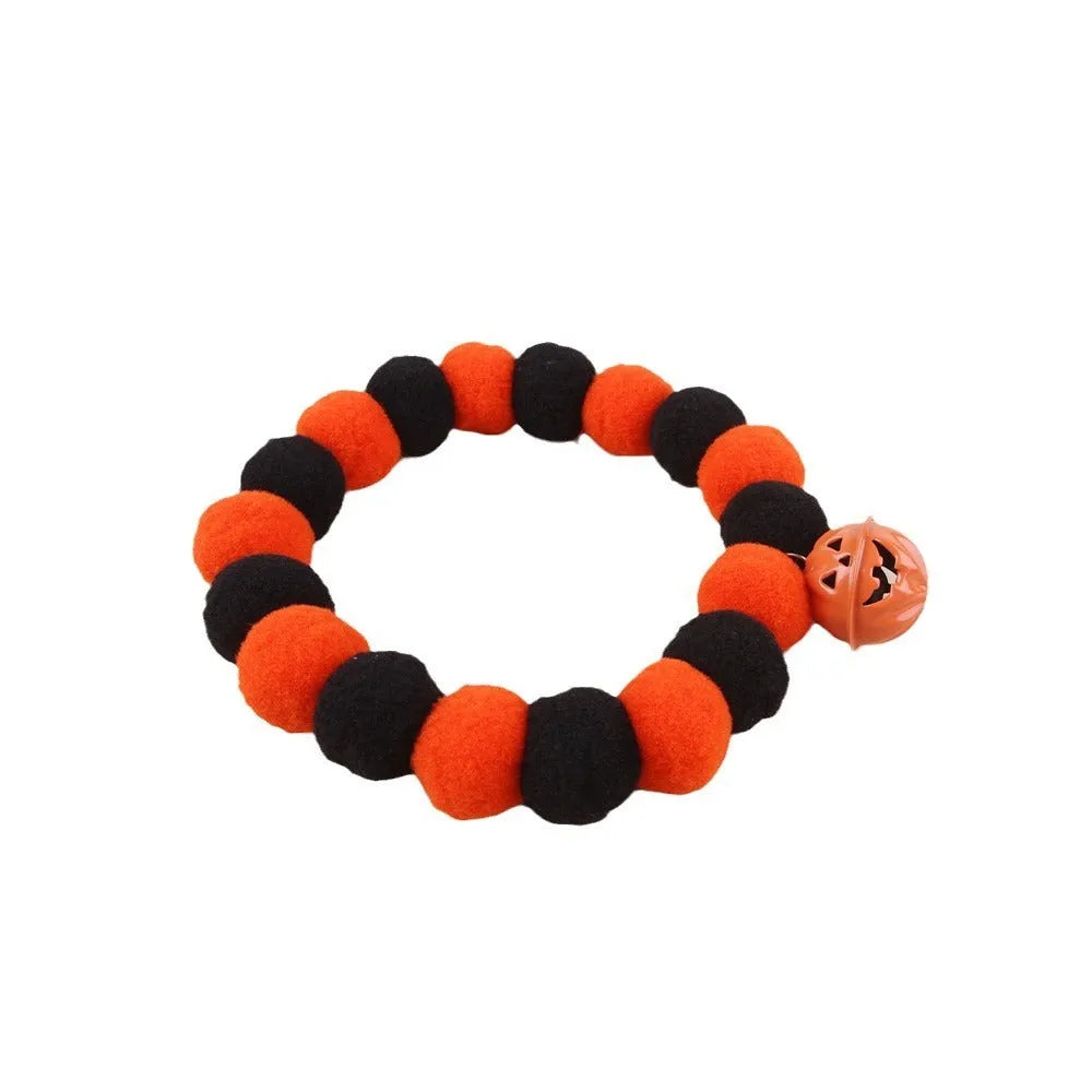 Orange and black Halloween cat collar with pumpkin design and plastic quick-release buckle.