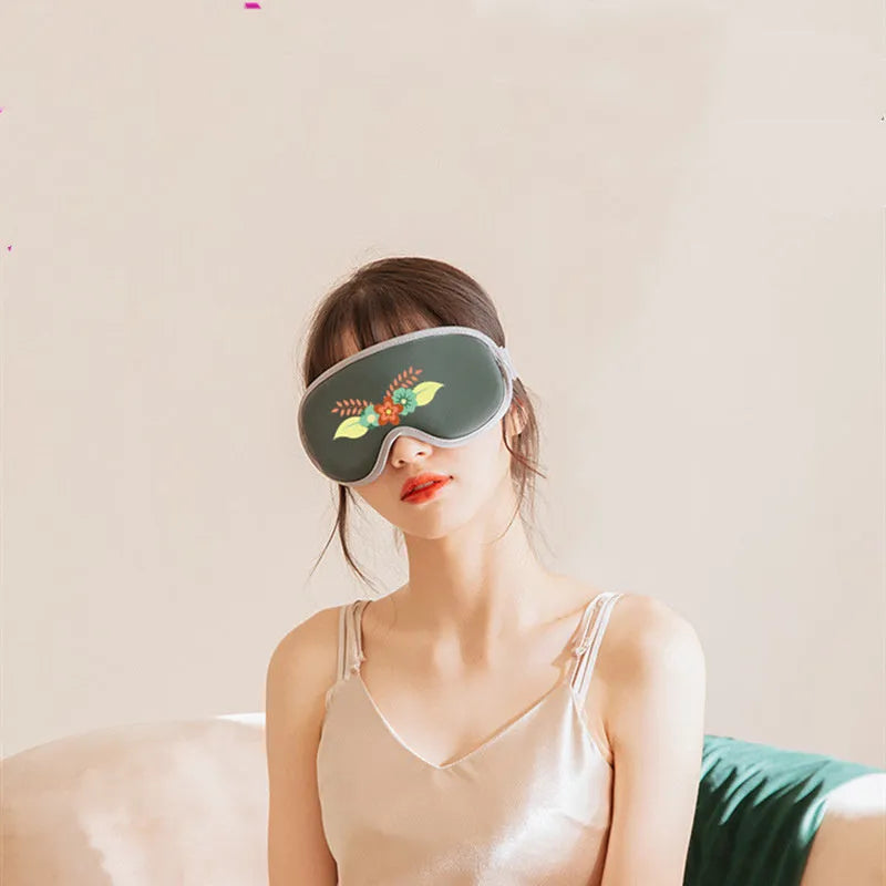 Portable eye spa massage goggles with suede exterior showing heat and vibration controls