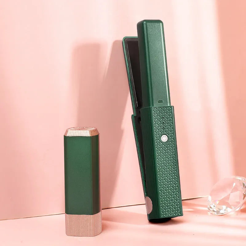 Pink and green mini cordless USB hair straightener with ceramic plates open on a white background.